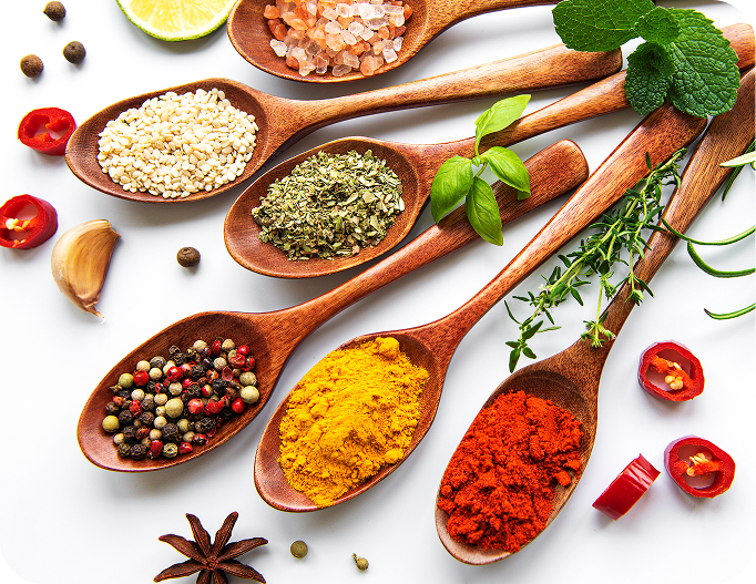 Various spices in wooden spoons